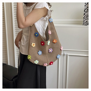 Détail du sac cabas au crochet marron avec des décorations florales tricotées en 3D