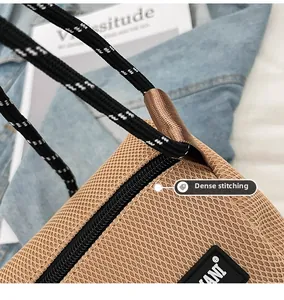 Detail of khaki mesh bag showing black and white drawstring cord and fine stitching