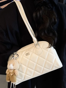 Chic beige quilted bowling bag with a cute bear pendant for stylish office women