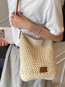 Handwoven hollow tote bag with brown leather straps for summer beach vacations