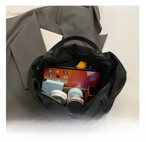Detailed interior of the black nylon tote bag showing high capacity for tablets and cosmetics
