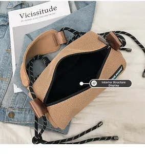 Detail view of khaki mesh crossbody bag featuring black zipper and spacious inner lining