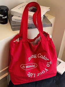 Minimalist red drawstring tote bag with artistic letter print for daily commute