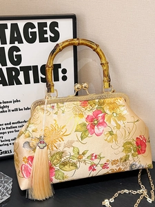 Vintage Chinese floral satin handbag with bamboo handle and elegant silk tassels
