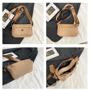 Detail view of multi-pocket nylon crossbody bag with adjustable wide fabric strap