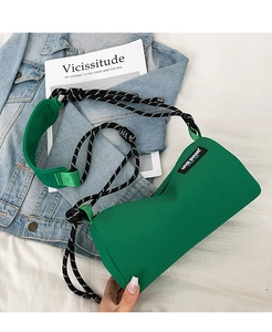 Detail of green mesh barrel bag with dual-tone rope strap and stylish brand label