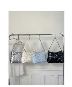 Detailed display of quilted leather handbags in silver, white, blue, and black colors