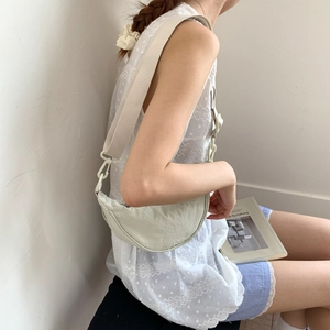 Close-up of lightweight crescent bag showing nylon texture and wide adjustable strap
