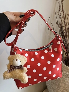 Mini red shoulder bag with white polka dots featuring a cute plush bear pendant