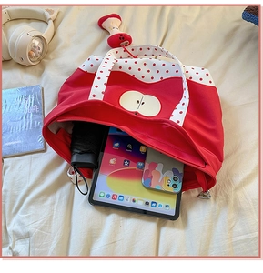 Detail of red canvas tote bag interior showing large capacity for tablet and accessories