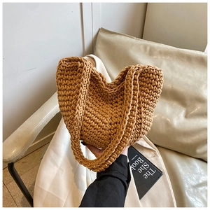 Close-up of caramel crochet knit tote bag showing intricate woven texture and U-shaped design