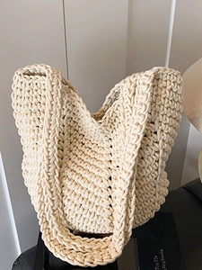 Minimalist cream hand-woven knit tote bag with braided texture and wide shoulder strap