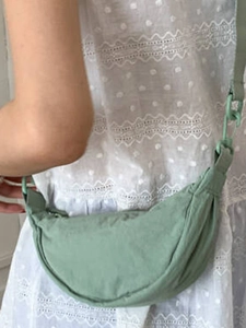 Minimalist avocado green crescent crossbody bag with adjustable fabric strap for women