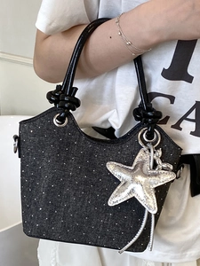 Chic black denim bucket bag with sparkling rhinestones and silver star pendant accessory