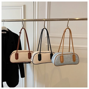 Three stylish bowling bags in canvas and tweed with leather trim on display