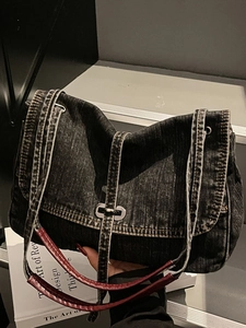 Washed dark gray denim shoulder bag with vintage leather strap and metal twist lock