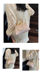 Detail of pink floral jacquard evening clutch with pearl handle and golden frame