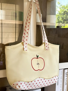 Chic beige canvas tote bag with embroidered apple and red polka dot pattern handle