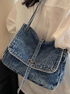 Fashionable dark blue washed denim tote bag with silver ring buckle and flap closure
