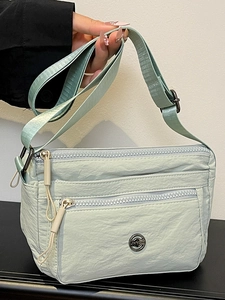 Chic mint green nylon crossbody bag with multi-layer zipper pockets for women