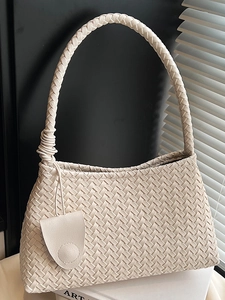 Handwoven beige underarm bag in premium faux leather with chunky braided shoulder strap