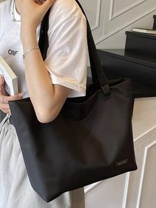 Minimalist large capacity black tote bag for women commuting with smooth nylon finish
