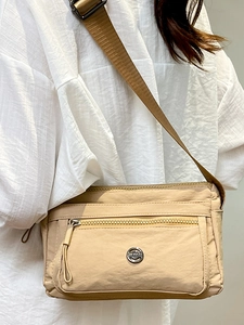 Minimalist beige nylon crossbody bag for women with multiple zipper compartments