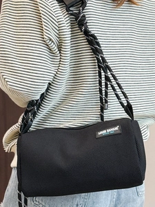 Fashionable black mesh crossbody bag with woven rope strap and brand patch on canvas