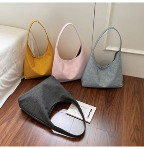 Detailed shot of large capacity tote bags in canvas felt on wood floor background