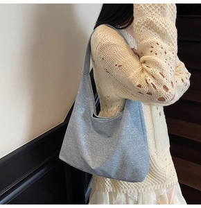 Close-up of light blue canvas tote bag with textured fabric and seamless shoulder strap