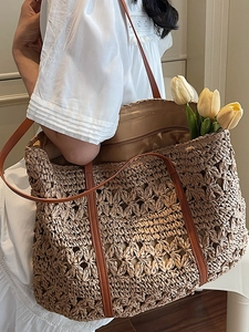 Summer hollow straw tote bag with brown leather handles and zipper for beach vacation