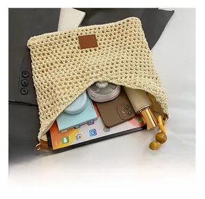 Macro view of beige crochet tote showing spacious interior and large wooden bead strap