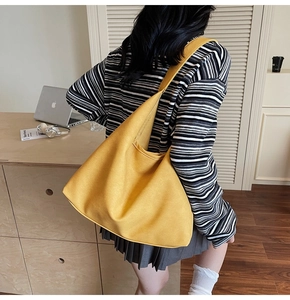 Large yellow canvas tote bag shown in a professional office setting with wide shoulder strap