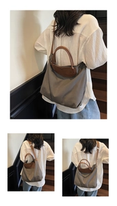 Detail of grey canvas tote bag with brown leather handles and logo embossing details