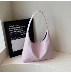 Detail of lavender saddle underarm bag showing high-quality wool-like texture and minimal design