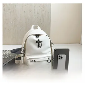 Gothic white PU leather backpack with cross pendant shown next to a tablet for scale