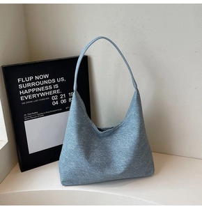 Close-up of blue snowflake texture fabric on this minimalist women's underarm tote bag