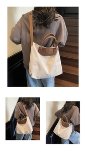 Detail of canvas and brown leather tote bag with stylish wide shoulder strap on stairs