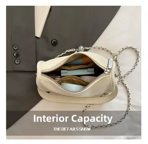 Detail showing internal capacity for phone and makeup in white crocodile texture bag