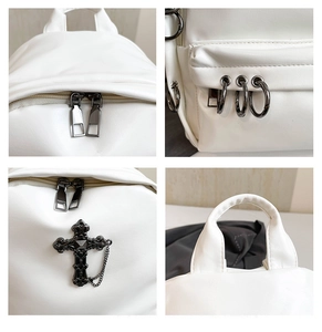 Close-up of white PU leather backpack featuring gothic cross and metal chain details