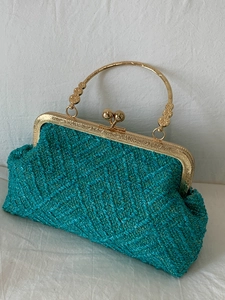 Elegant woven turquoise evening shell bag with golden metal handle and clasp closure