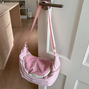 Detail of pink nylon dumpling bag with watermelon embroidery and adjustable strap