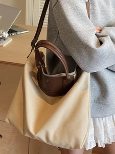Minimalist large canvas tote bag for women with leather trim shown in office setting