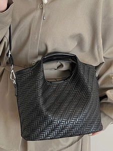 Chic black woven handbag with adjustable shoulder strap and silver hardware for women