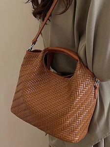 Deep brown woven leather handbag with shoulder strap and circular handle for women