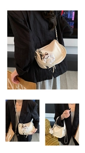 Chic cream underarm bag with metal chain strap and cute plush dog pendant on the side