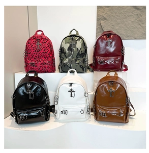 Collection of punk style backpacks with gothic metal crosses and rings in various colors