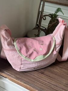 Pink watermelon-shaped nylon crescent crossbody bag with seeds detail and green trim