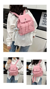 Detail view of pink polka dot backpack featuring star pendant and faux leather texture
