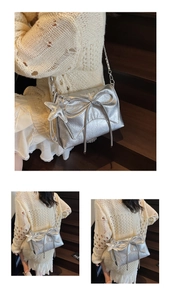 Detailed macro view of silver metallic pleated shoulder bag with bow and star pendant